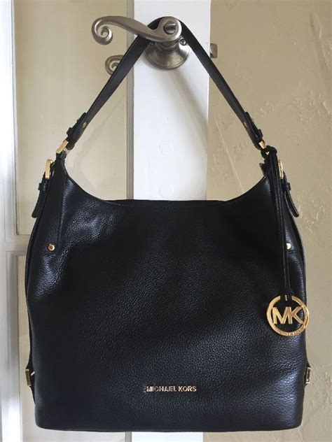 michael kors black purse gold hardware|Michael Kors large gold tote.